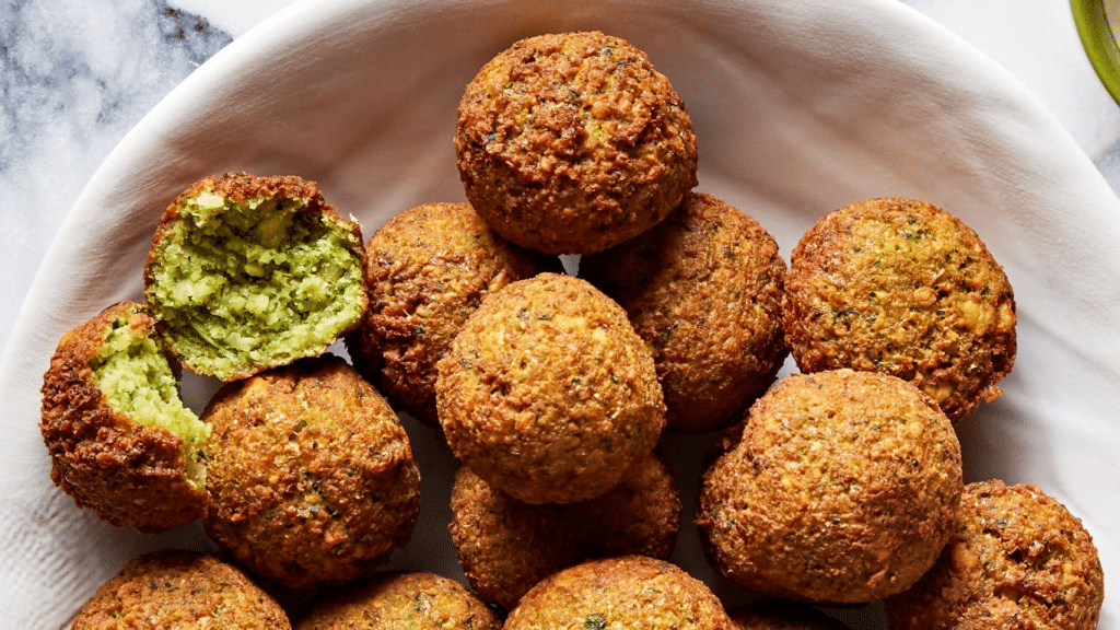 Falafel is a Middle Eastern food consisting of deep fried balls of chickpeas or fava beans. 